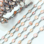 Load image into Gallery viewer, Coated Peach Moonstone Round Shape Bezel Oxidized Wire Chain.