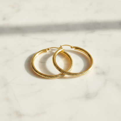 GER67. 14K Gold Hollow Hoop Earrings with Engraved Tornado Design