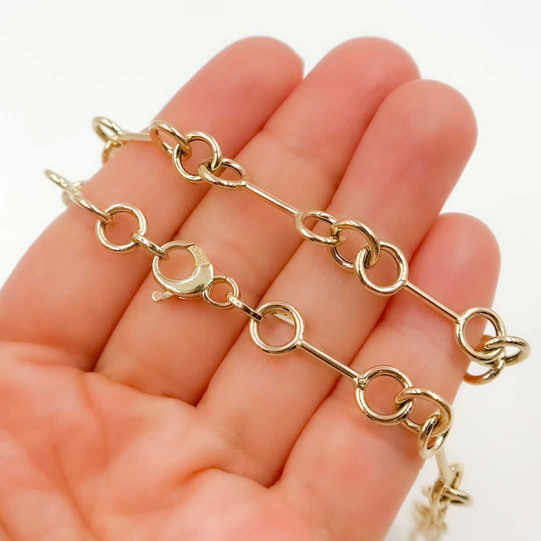 568/A080. 14K Solid Gold Hollow Bar and Rings Necklace